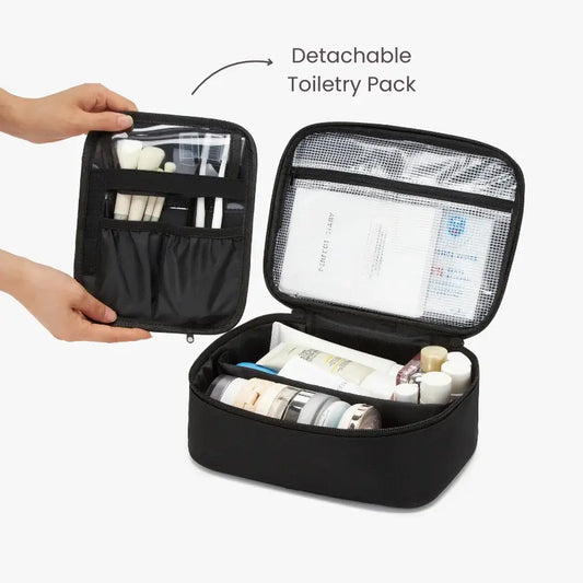 Black toiletry pack with detachable pouch containing travel accessories on a white background.