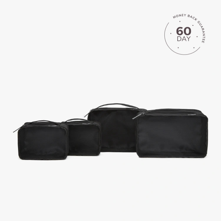 A set of beige packing cubes of various sizes with a white cube labeled '60 DAY'.