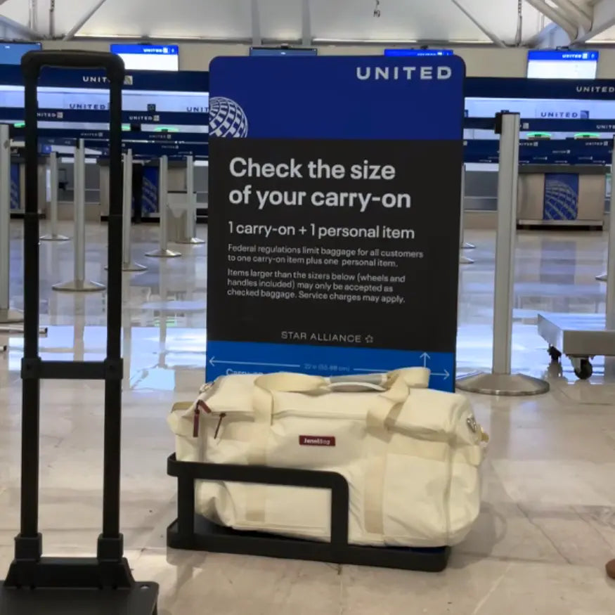 White bag on a luggage scale with a United Airlines sign in an airport.