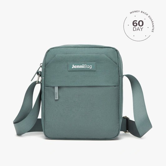 A beige Jenni crossbody bag with a zipper closure and an adjustable strap, displayed against a white background.