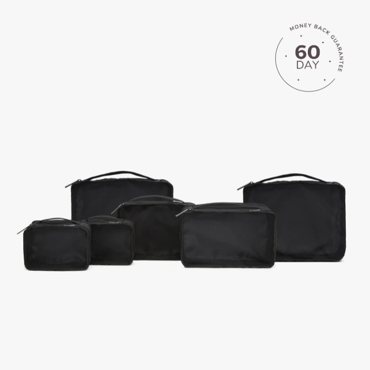 A set of beige packing cubes of various sizes with a white cube labeled '60 DAY'.