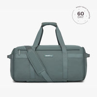 A beige travel duffel bag with multiple compartments and a shoulder strap, displayed against a white background with a '60 DAY' guarantee seal in the top right corner.