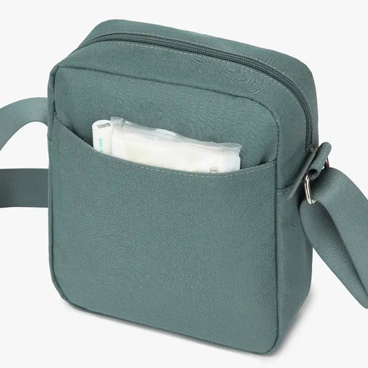Green shoulder bag with a pocket open on a white background