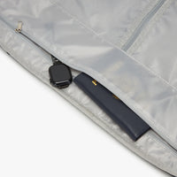 Close-up of a gray garment bag with a black zipper and handle.