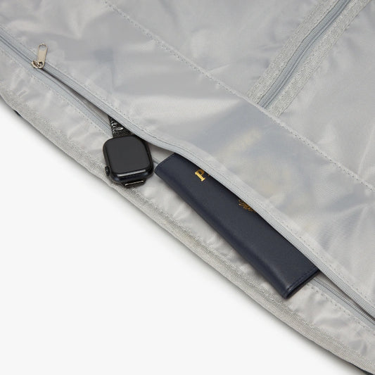 Close-up of a gray garment bag with a black zipper and handle.