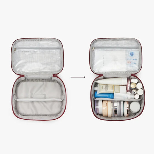 Open travel case with toiletries on a white background
