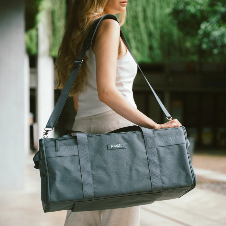Woman carrying a dark blue bag outdoors
