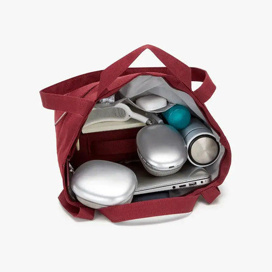 Red bag with electronic devices inside on a white background