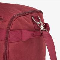 Close-up of a maroon bag's zipper and strap.