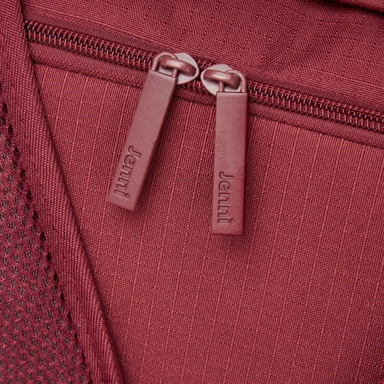 Close-up of a zipper pull on a red bag.