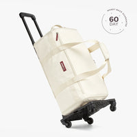 A beige travel duffel bag with multiple compartments and a shoulder strap, displayed against a white background with a '60 DAY' guarantee seal in the top right corner.