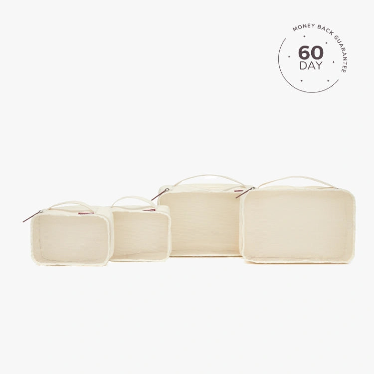 A set of beige packing cubes of various sizes with a white cube labeled '60 DAY'.