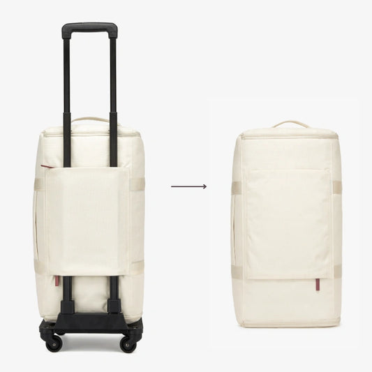 White rolling suitcase and backpack side by side on a plain background