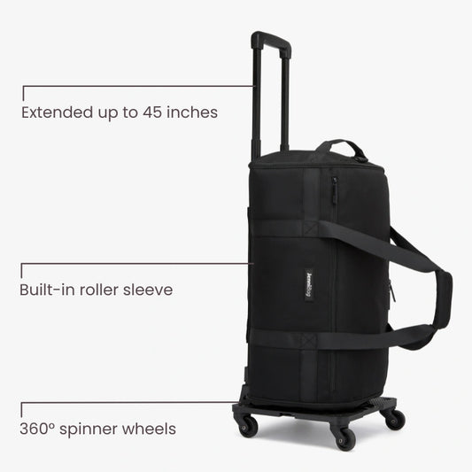 Black rolling suitcase with extended handle and 360-degree spinner wheels on a white background.