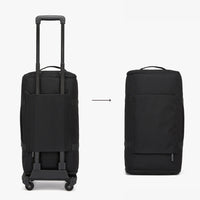 Black rolling suitcase and standalone bag on a white background