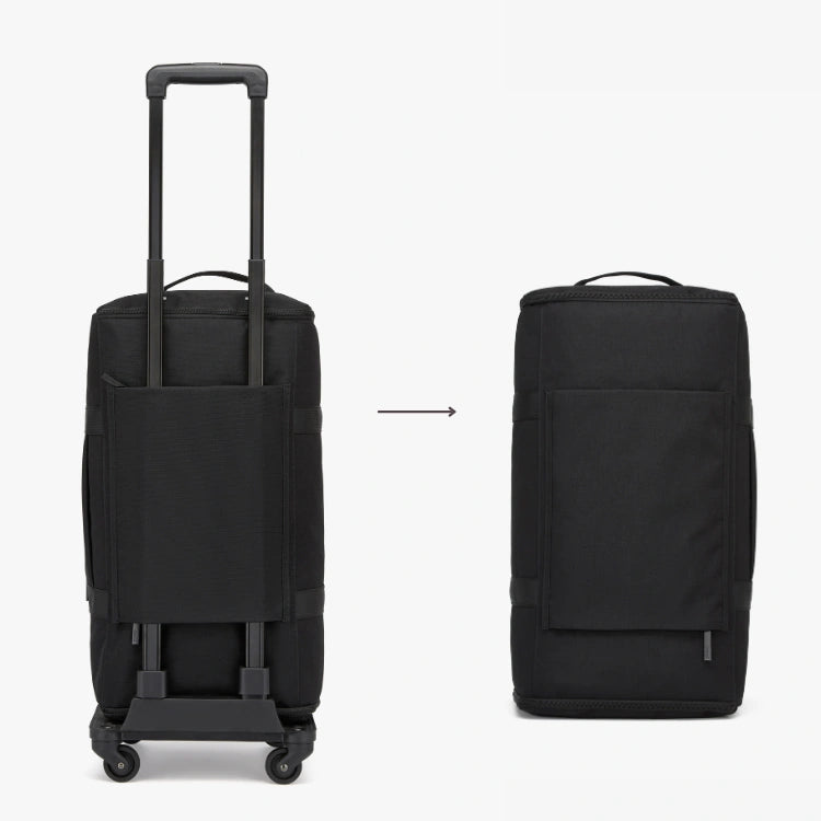 Black rolling suitcase and standalone bag on a white background