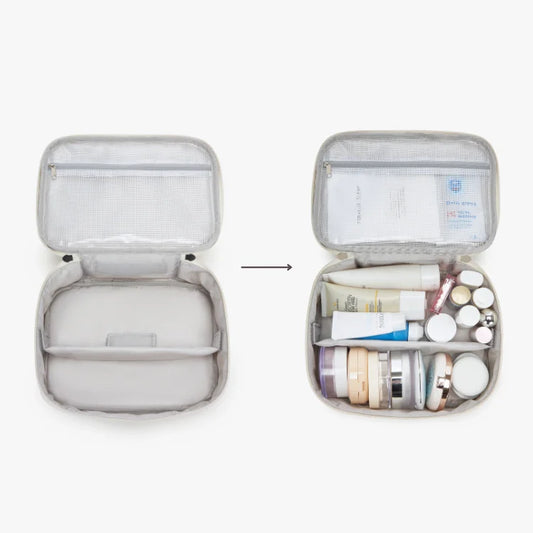 Portable travel case with compartments filled with skincare products on a white background.