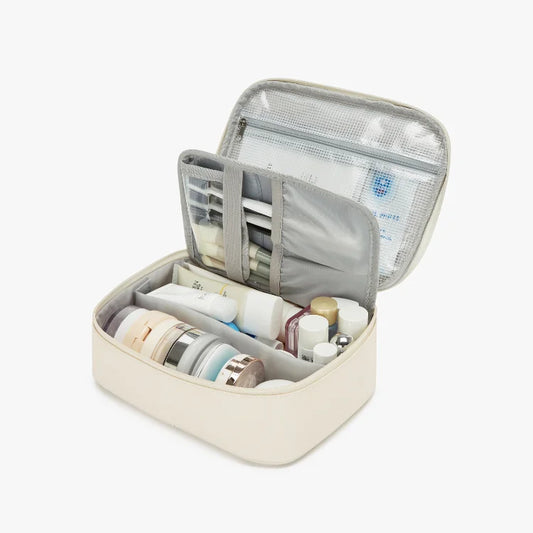 Open travel case with toiletries on a light background