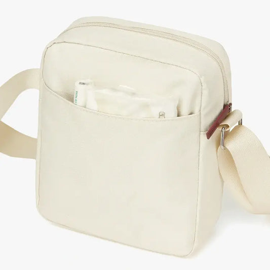 Beige shoulder bag with a pouch on a white background
