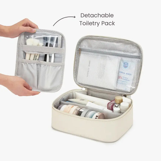 Detachable toiletry pack with travel accessories on a plain background