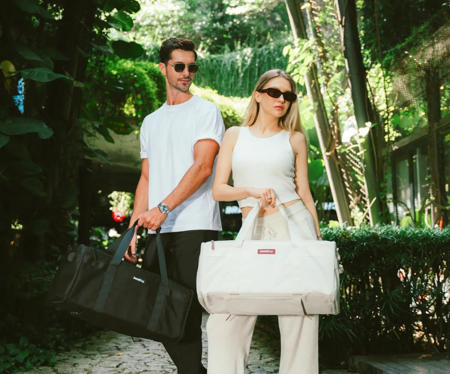Man and woman walking in a garden with bags