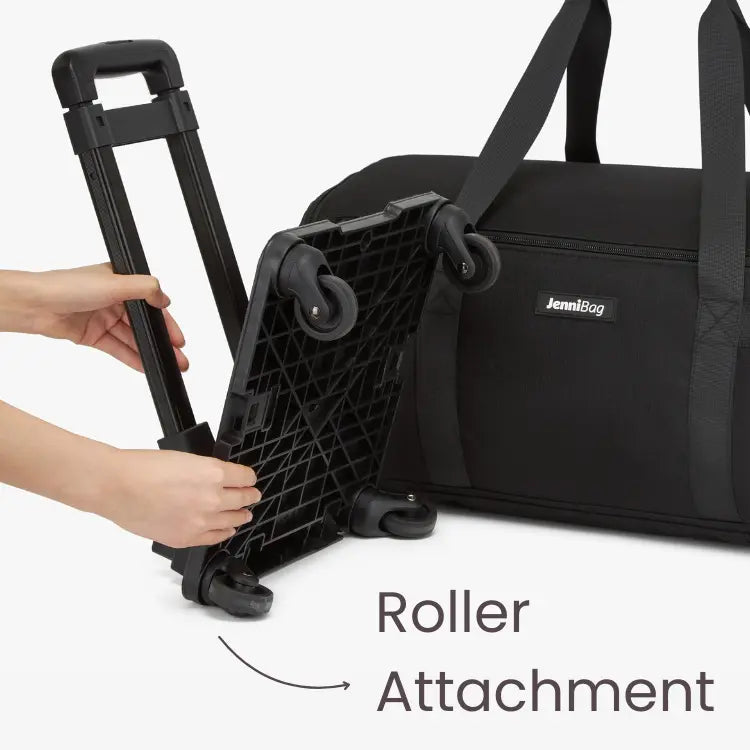 A hand attaching a black roller attachment to the bottom of a black bag, with the text 'Roller Attachment' labeled.