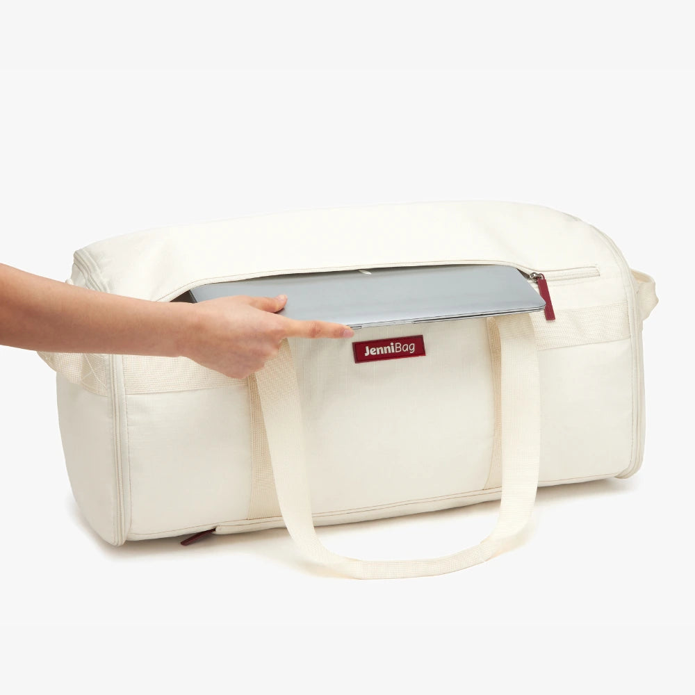 White diaper bag with a hand holding a tablet, on a white background