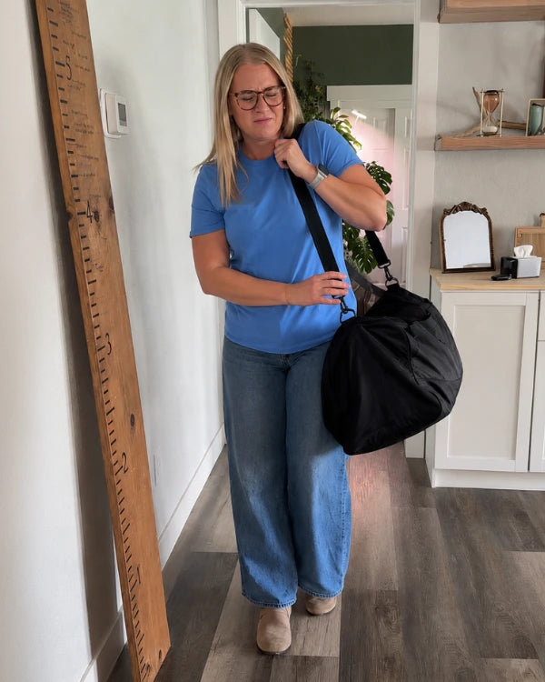 Traveler managing several travel bags