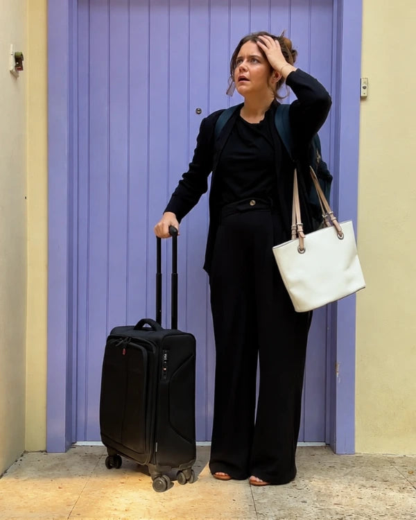 Traveler managing several travel bags