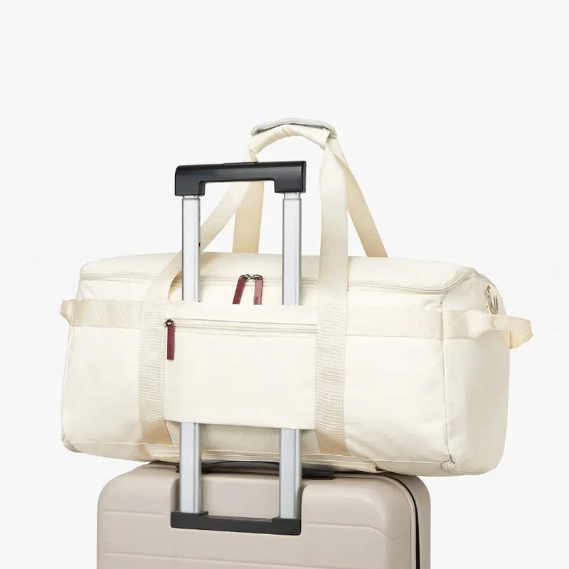 JenniBag slid over a suitcase handle with its trolley sleeve