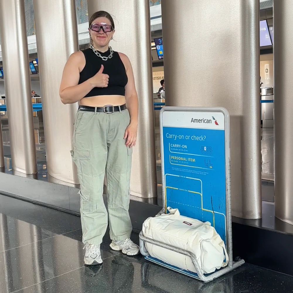 JenniBag being placed into an airline overhead bin